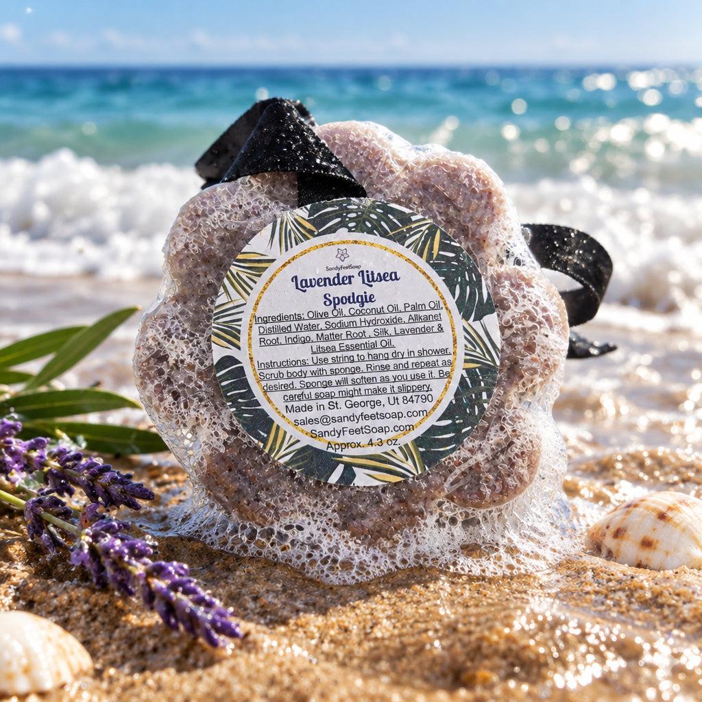 lavender soap sponge wrapped in clear plastic with a black ribbon and a circular label reading 'Lavender Lysea Squiggle' on a plain white background.